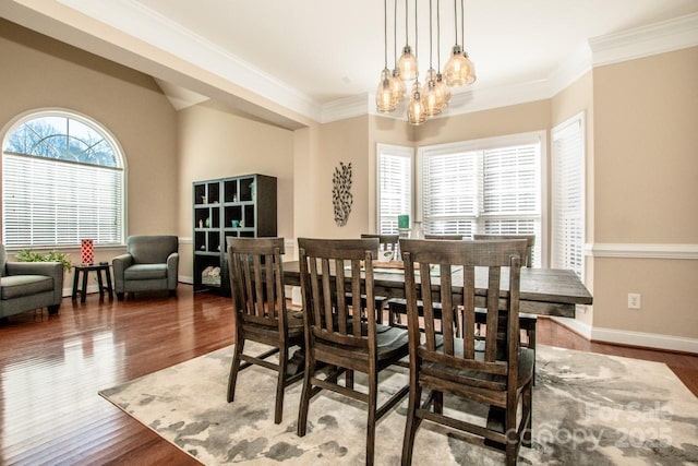 dining room featuring wood-type flooring, a notable chandelier, and crown molding