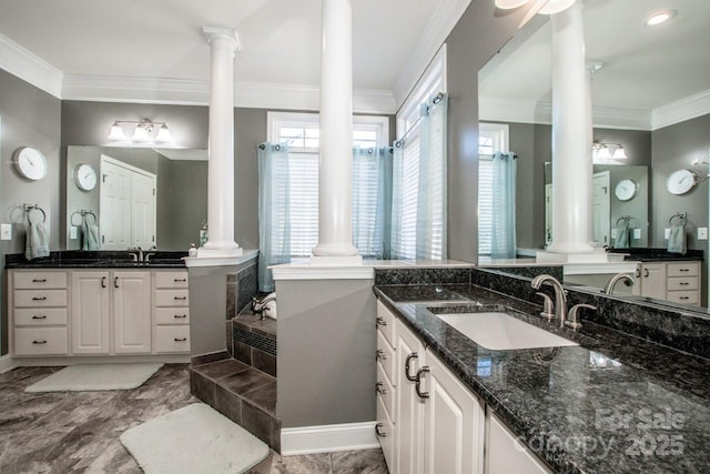 bathroom with tiled bath, crown molding, and vanity