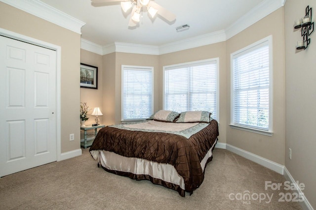 bedroom featuring multiple windows, ceiling fan, and light colored carpet