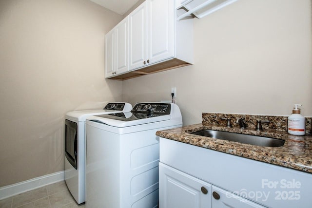 laundry room featuring cabinets, separate washer and dryer, light tile patterned floors, and sink