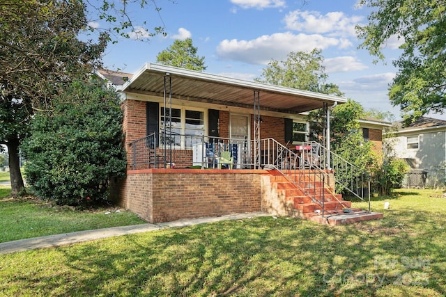 view of front of property with covered porch and a front lawn