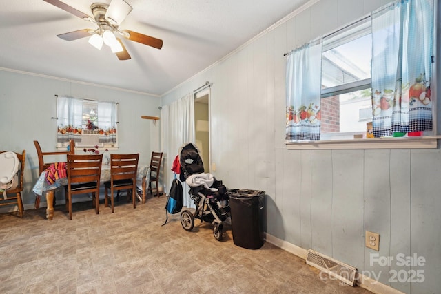 miscellaneous room featuring crown molding, a wealth of natural light, and ceiling fan