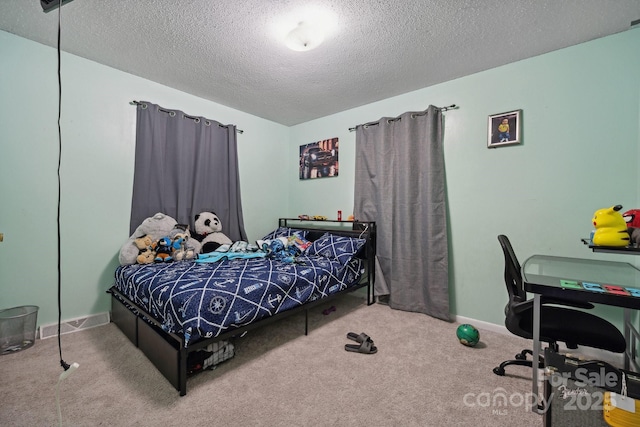 carpeted bedroom featuring a textured ceiling