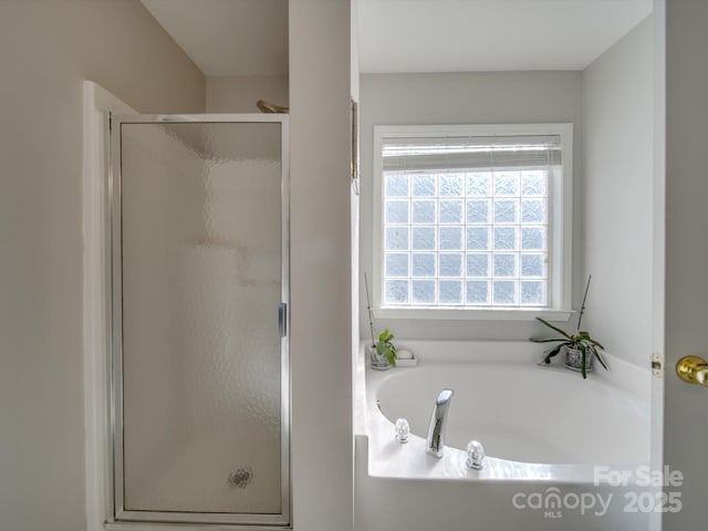 bathroom with shower with separate bathtub