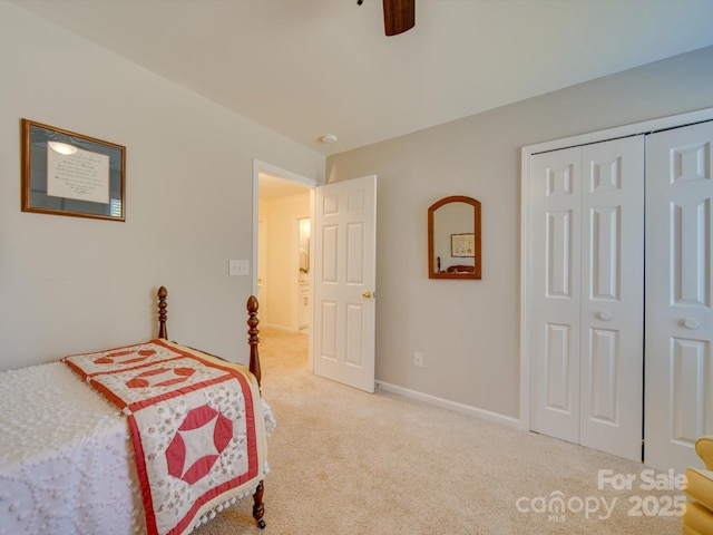 carpeted bedroom featuring ceiling fan and a closet