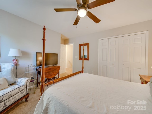 bedroom with ceiling fan, light colored carpet, and a closet