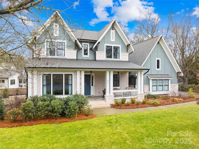 view of front of home featuring covered porch and a front lawn