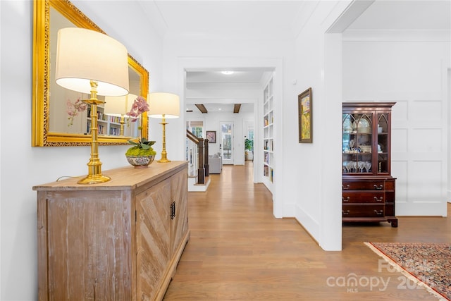 hall with crown molding and hardwood / wood-style flooring