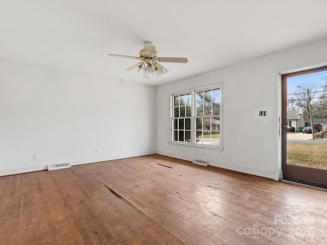 spare room with light wood-type flooring and ceiling fan