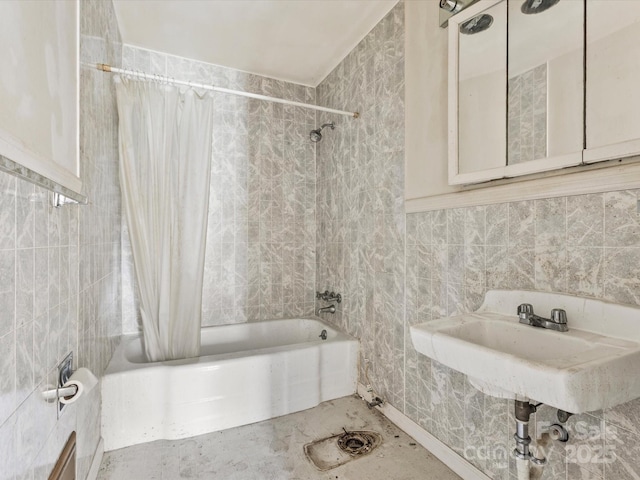 bathroom with tile walls and shower / bath combination with curtain