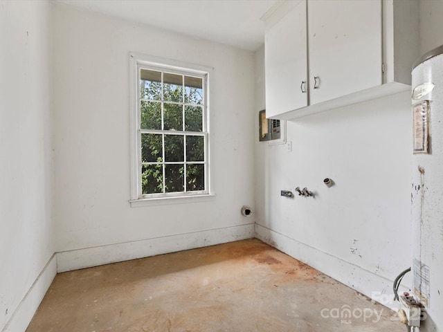 clothes washing area with cabinets