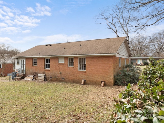 rear view of property with a lawn