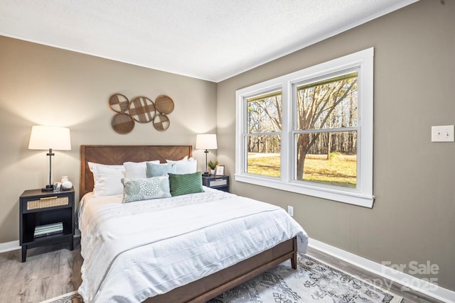 bedroom featuring a textured ceiling and wood-type flooring