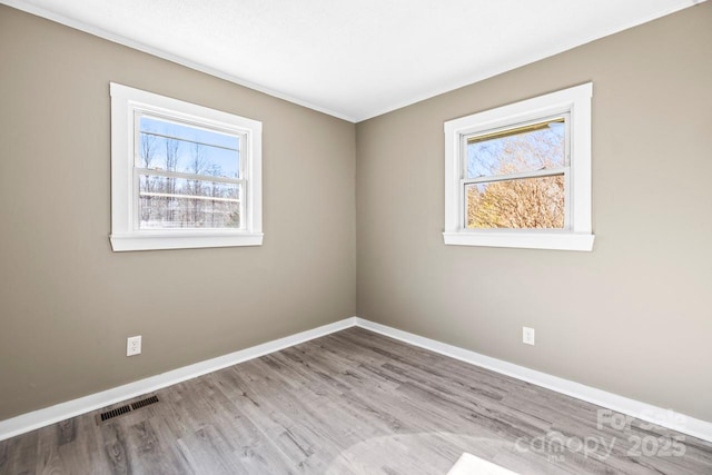 spare room featuring light hardwood / wood-style flooring