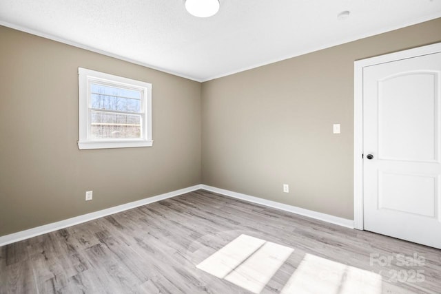 spare room featuring light hardwood / wood-style flooring