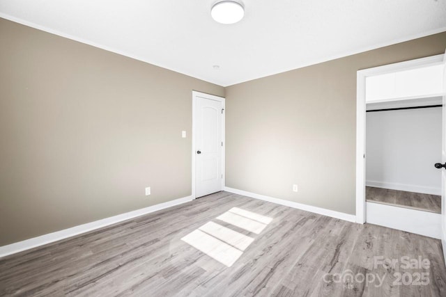 unfurnished bedroom featuring a closet and light hardwood / wood-style flooring