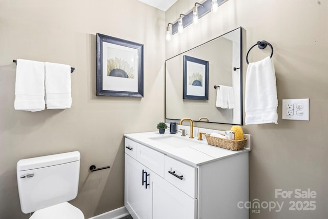 bathroom with toilet and vanity