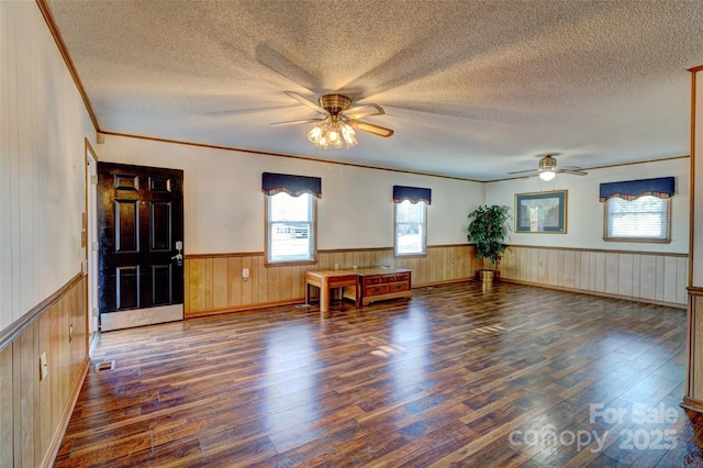 foyer featuring crown molding, ceiling fan, and dark wood-type flooring