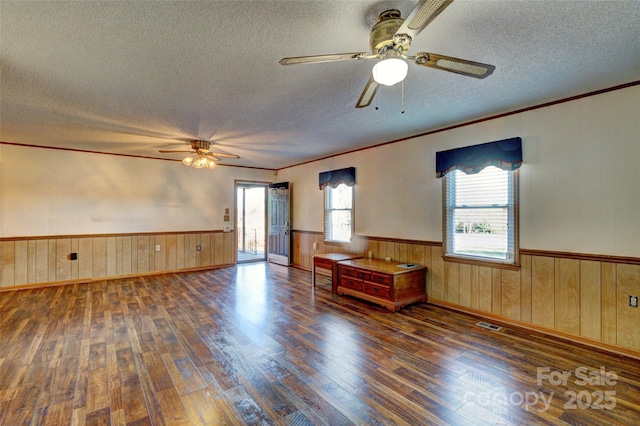 spare room featuring a textured ceiling, ceiling fan, and dark hardwood / wood-style floors