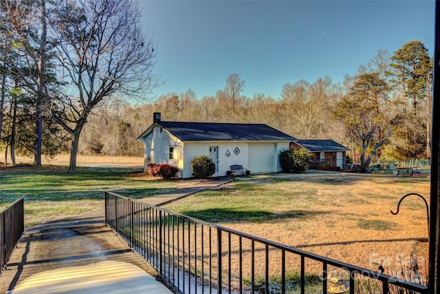 exterior space with a garage and a lawn