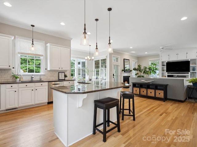 kitchen featuring ceiling fan with notable chandelier, white cabinetry, and dishwasher