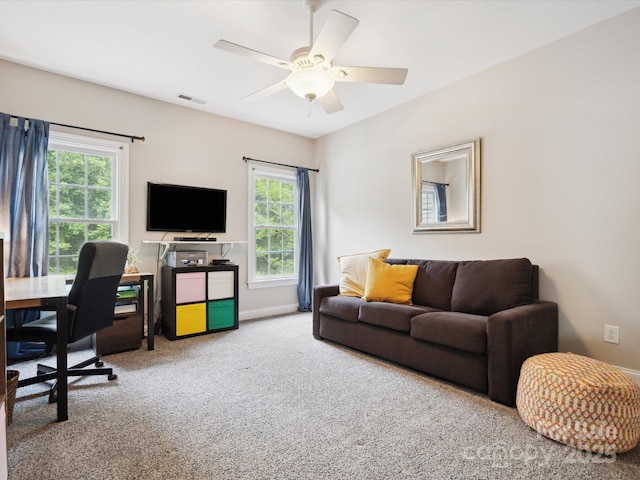 living room with ceiling fan and carpet flooring