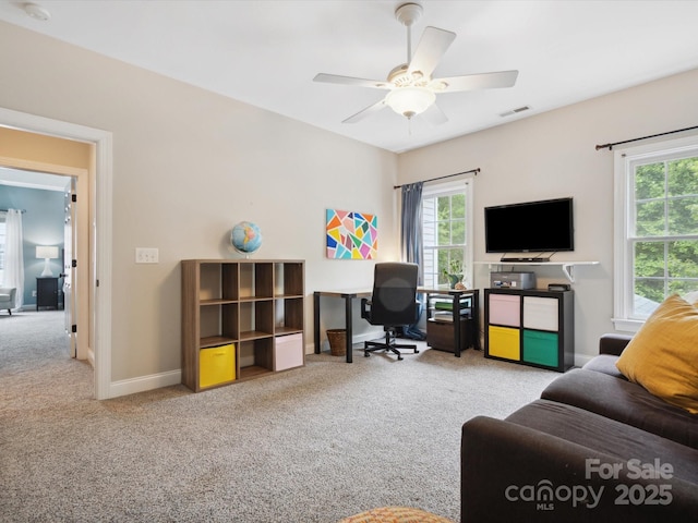 carpeted office space with ceiling fan