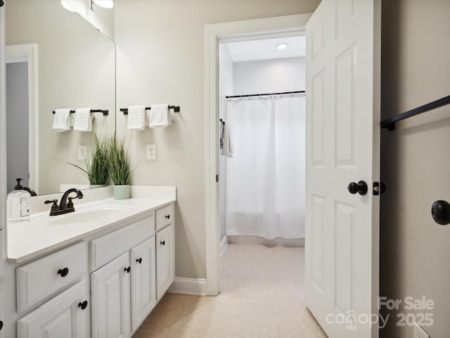 bathroom featuring vanity and curtained shower