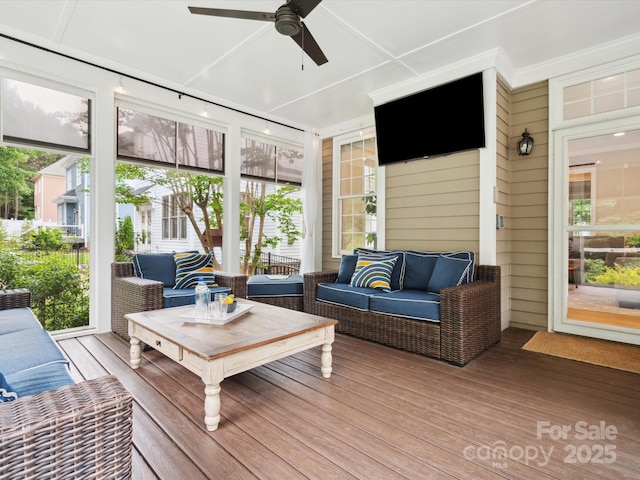 sunroom / solarium featuring ceiling fan