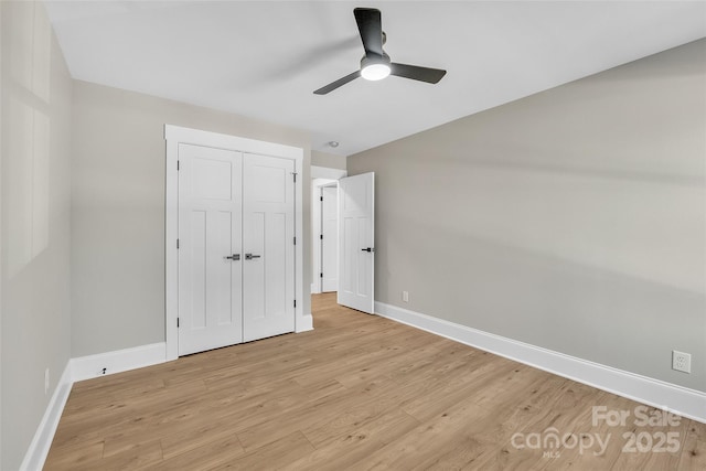 unfurnished bedroom with ceiling fan, a closet, and light hardwood / wood-style flooring