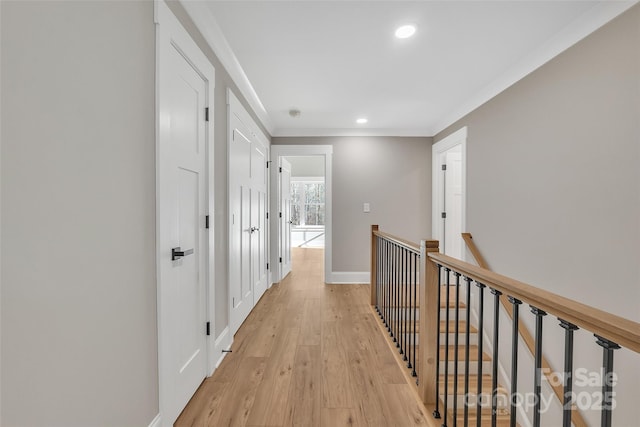 hall featuring light wood-type flooring and crown molding