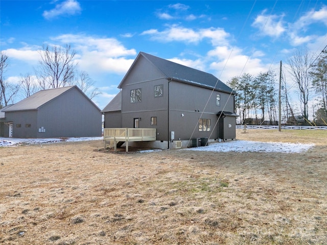 rear view of property with a wooden deck