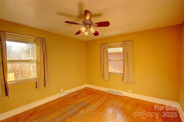 spare room featuring ceiling fan and wood-type flooring