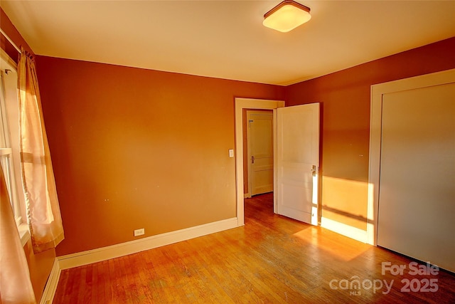 unfurnished bedroom with hardwood / wood-style floors