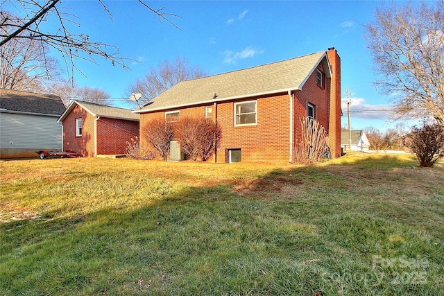 rear view of property with a yard