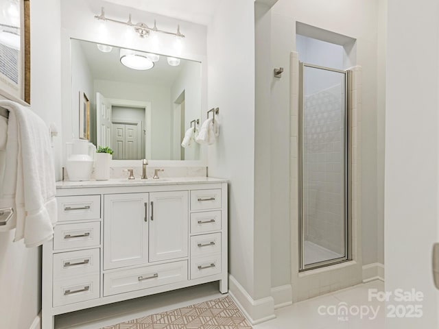 bathroom featuring tile patterned flooring, vanity, and a shower with shower door