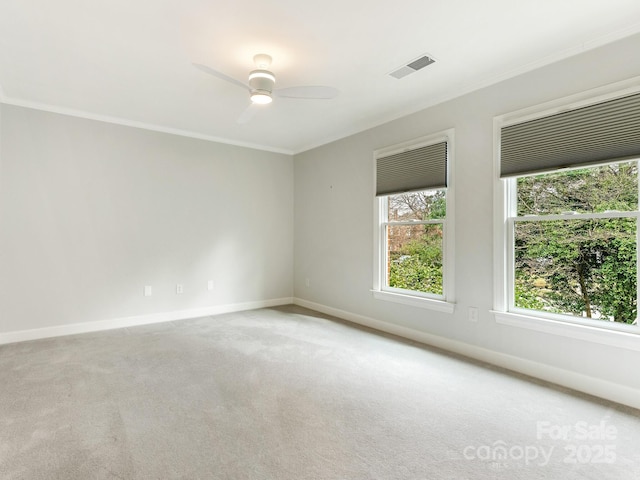 carpeted empty room with crown molding and ceiling fan