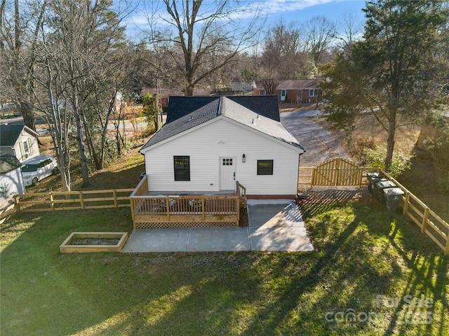 back of property with a patio area, a deck, and a yard