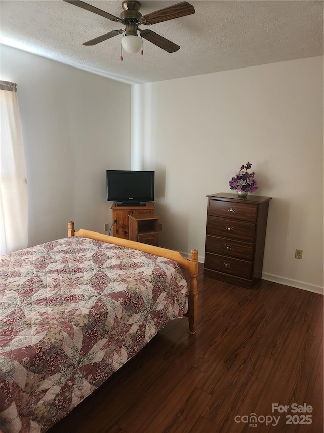 bedroom featuring a textured ceiling, ceiling fan, dark hardwood / wood-style flooring, and multiple windows