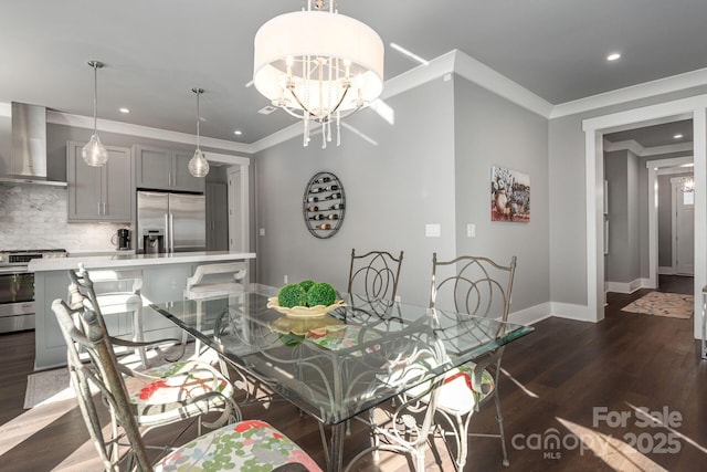 dining space with ornamental molding, dark hardwood / wood-style flooring, and an inviting chandelier