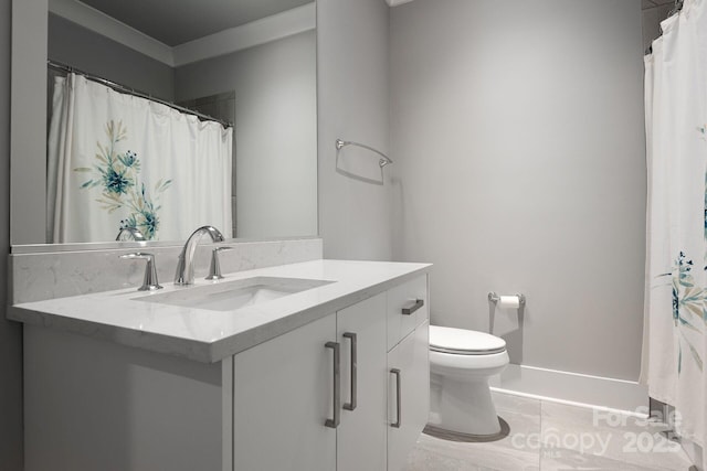 bathroom with toilet, vanity, and tile patterned floors