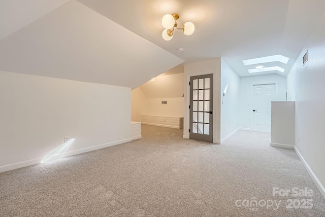 bonus room featuring carpet flooring and vaulted ceiling with skylight