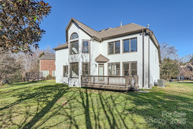 back of house featuring central AC, a wooden deck, and a lawn