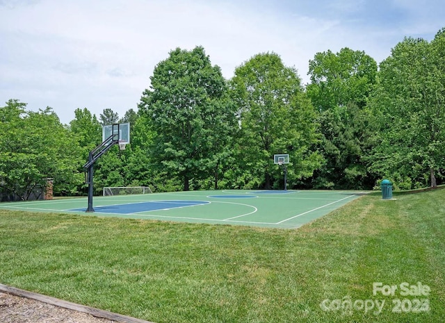 view of sport court featuring a lawn