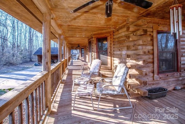 wooden deck featuring ceiling fan