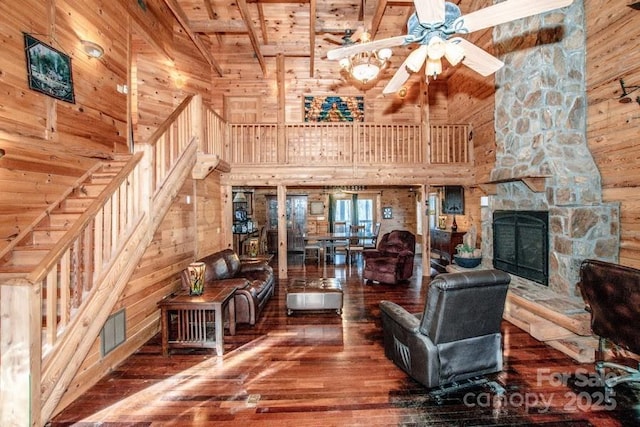 unfurnished living room featuring hardwood / wood-style floors, wood ceiling, a fireplace, high vaulted ceiling, and beam ceiling