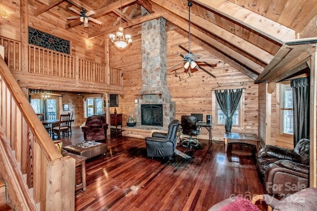 living room with beam ceiling, hardwood / wood-style flooring, and high vaulted ceiling