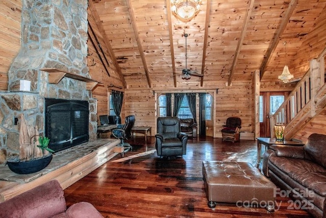 living room featuring a fireplace, beamed ceiling, wooden walls, hardwood / wood-style flooring, and wooden ceiling