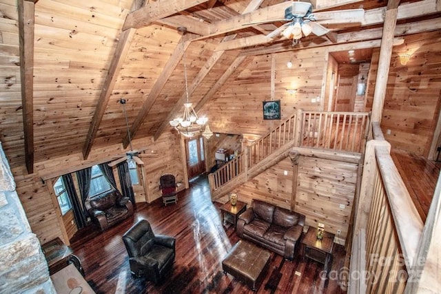 unfurnished living room featuring wooden walls, wooden ceiling, ceiling fan, dark wood-type flooring, and lofted ceiling with beams