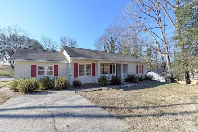 single story home with covered porch and a front lawn